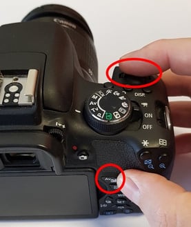 How to hold AV bottom and turn the wheel of a Canon EOS Digital SLR Camera to set Exposure Compensation to +2EV