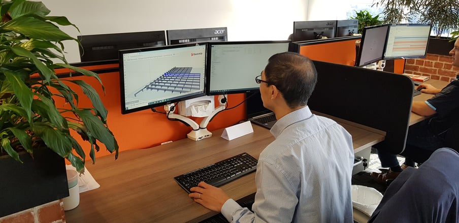 Geological Product Specialist working on a roller racking plan on his computer