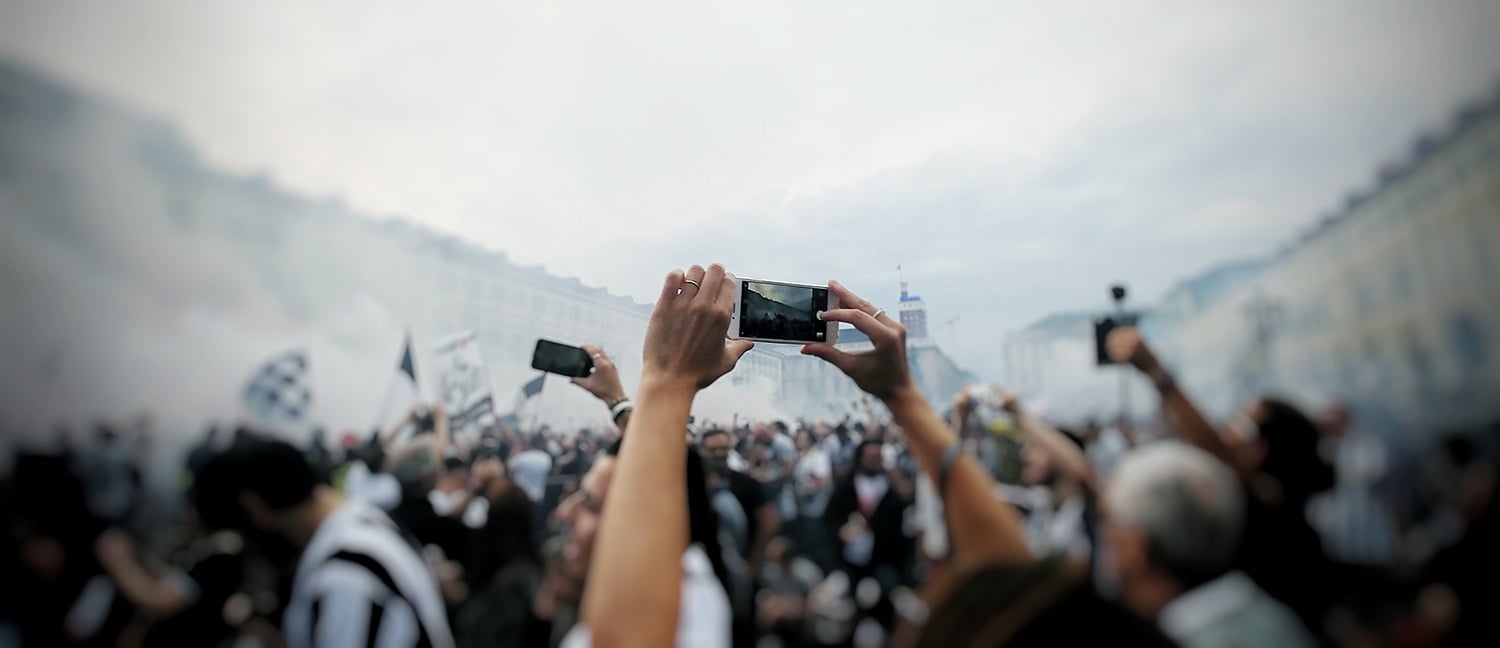 Smartphones being used by a crowd outdoors