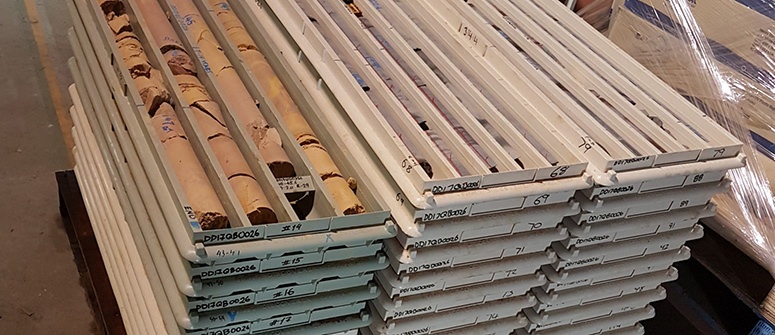 Stacks of plastic core trays with irregularly shaped core samples